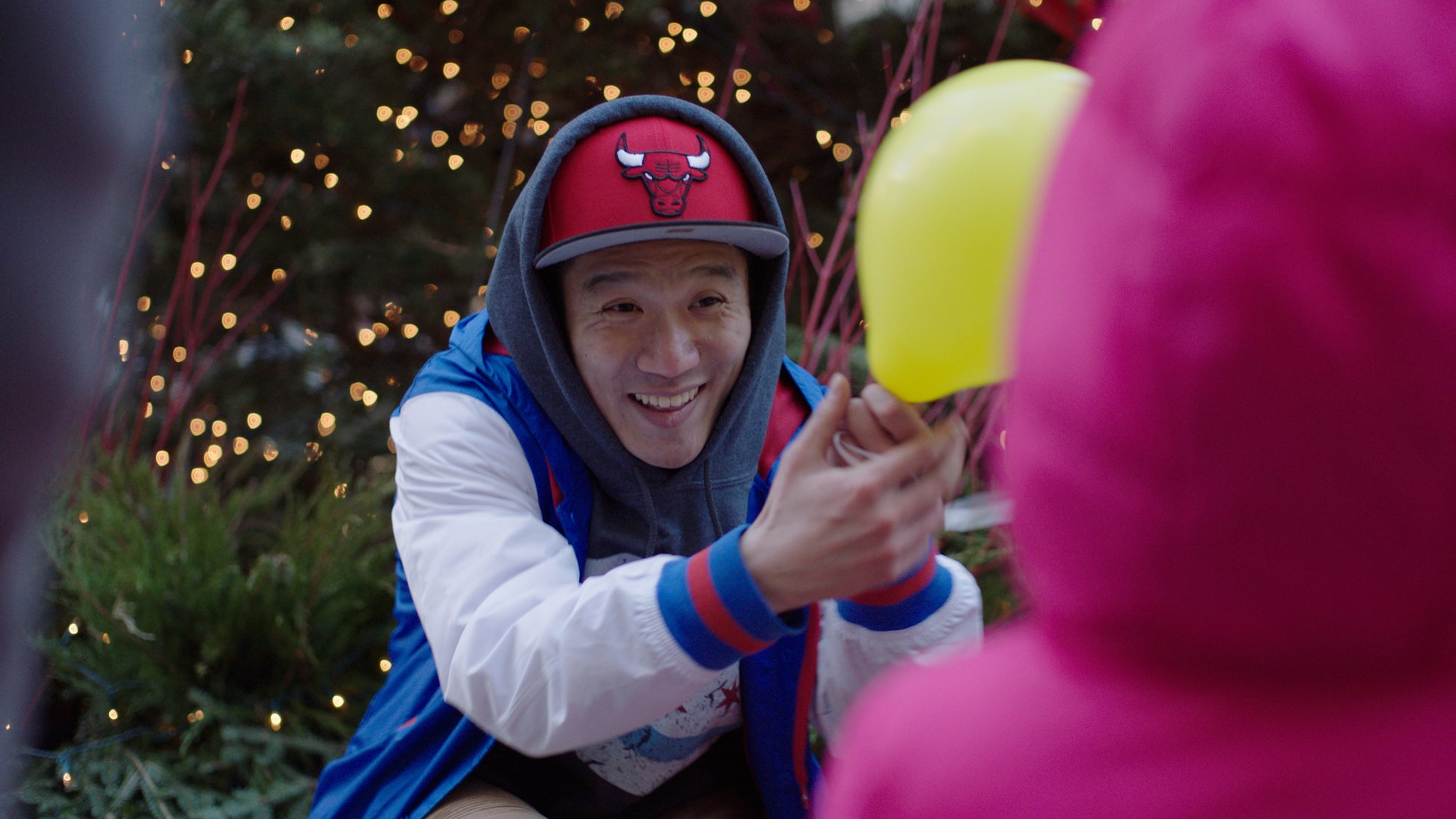 Person wearing a red Bulls cap with a Christmas tree in the background