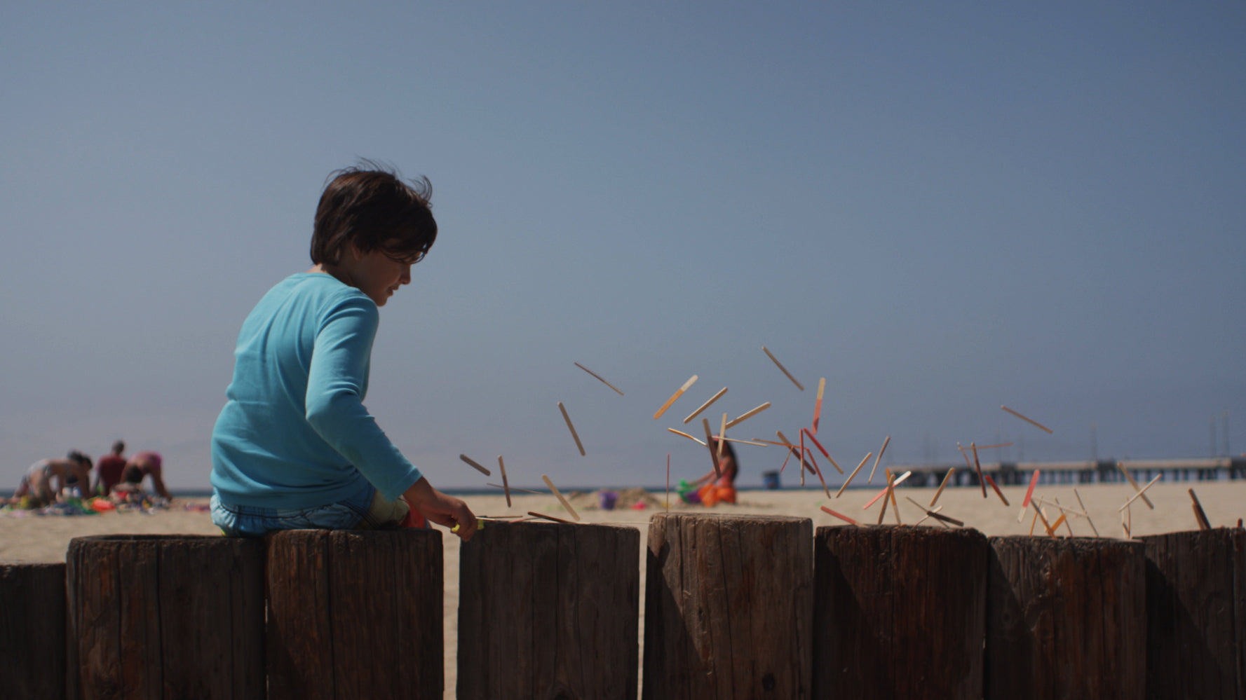 Person working with sticks on a beach