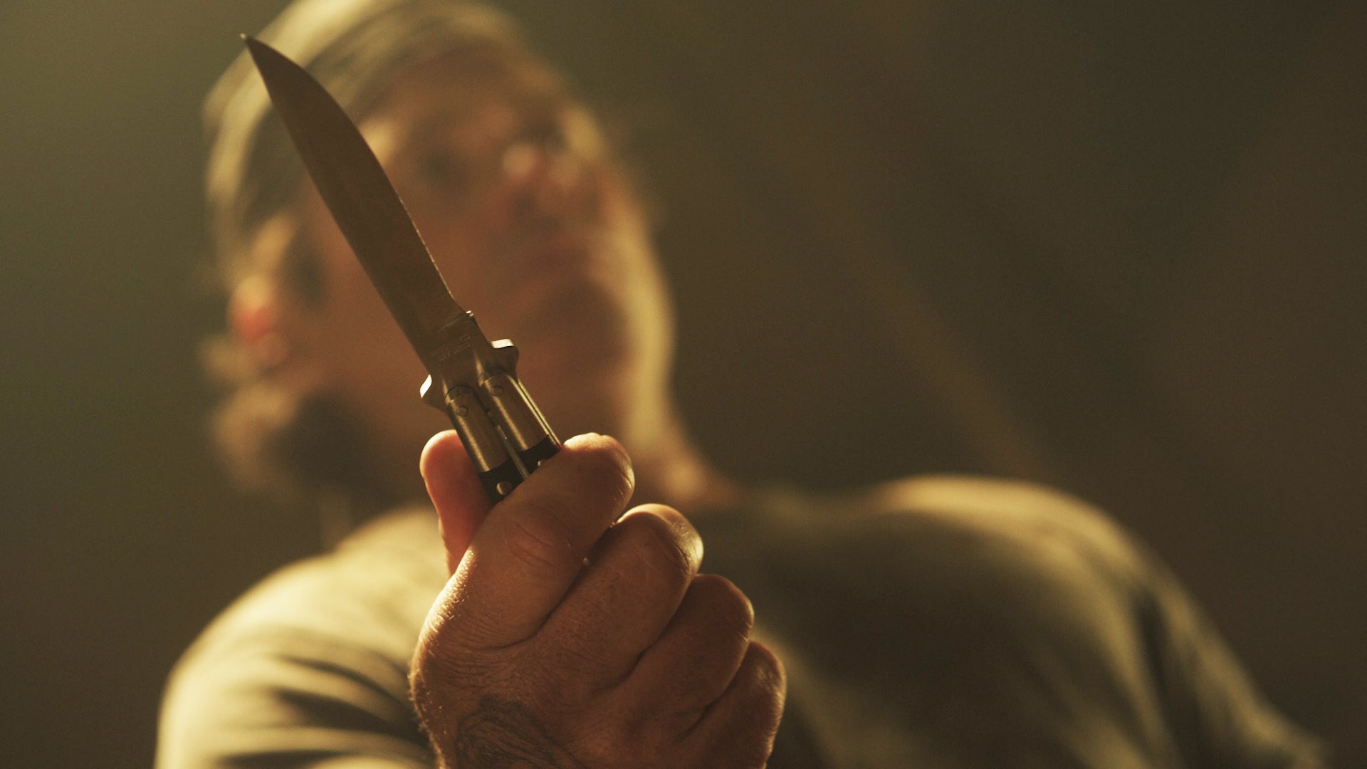 Person holding a knife with a blurred background