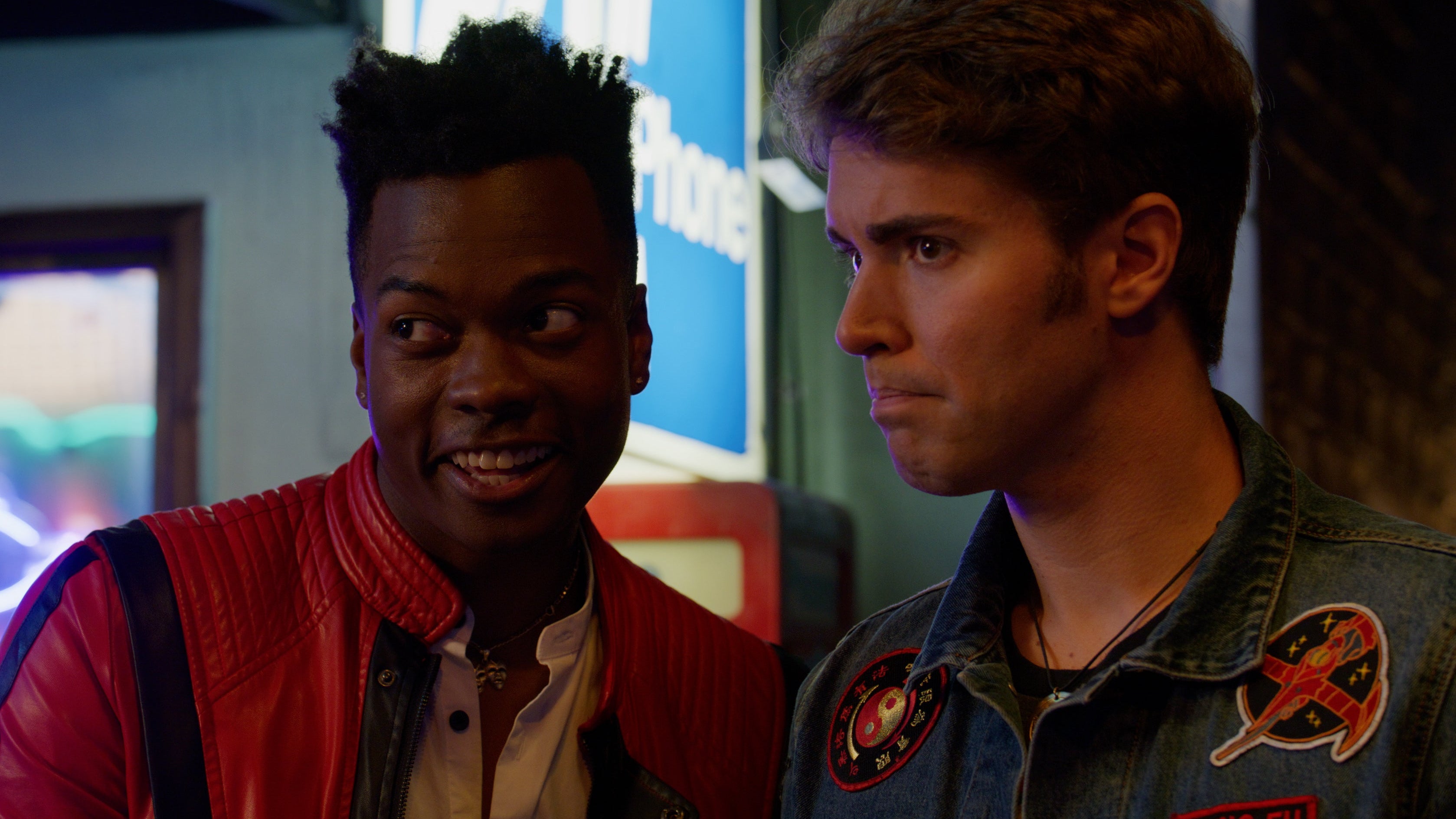 Two characters in a conversation with a colorful background